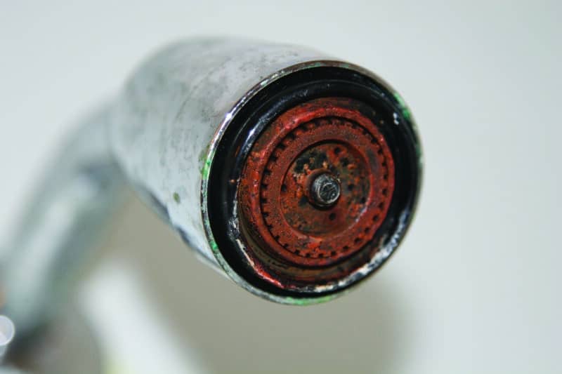 closeup of a iron stained shower head