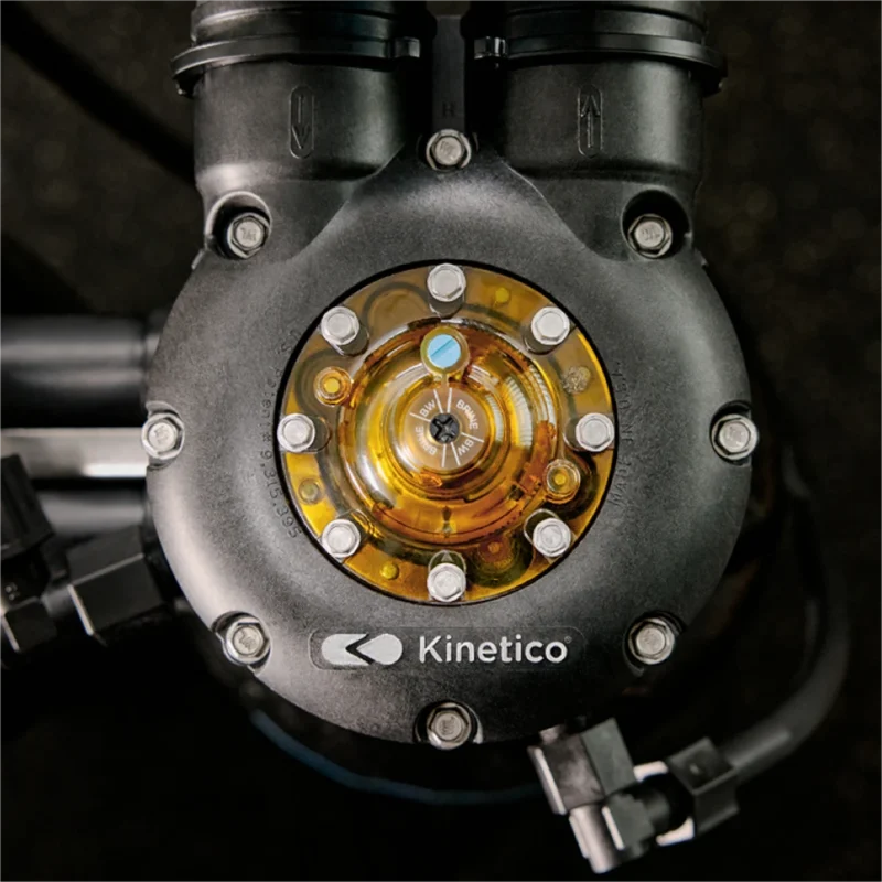 A close-up of a Kinetico water softener in Round Rock featuring a circular transparent window on the valve that reveals internal components.